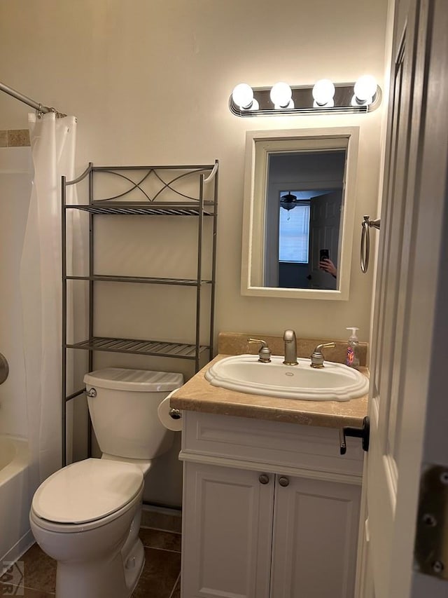 bathroom featuring toilet, tile patterned floors, shower / bath combo, and vanity