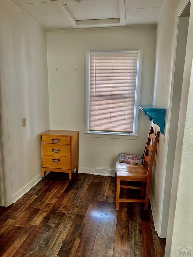 miscellaneous room featuring dark wood-style flooring, visible vents, and baseboards