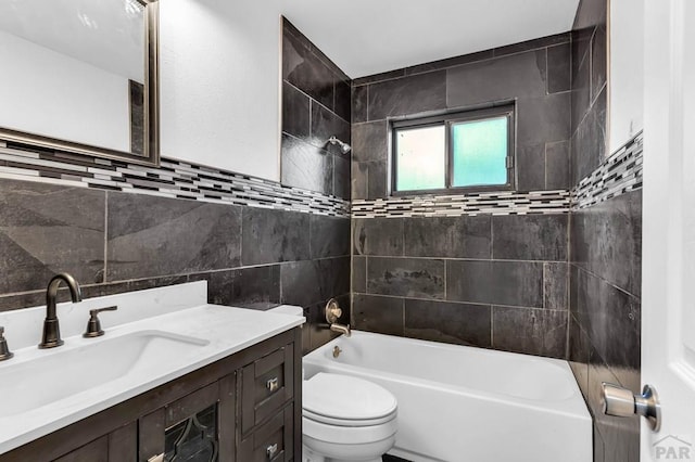 2720 E 8th St, Pueblo, CO 81001 - bathroom featuring bathtub / shower combination, tile walls, and vanity