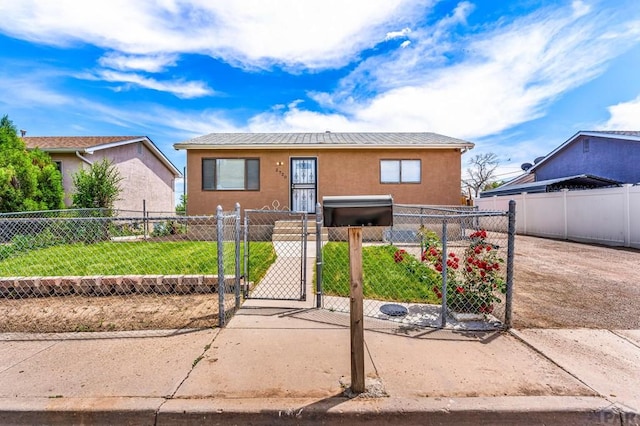 2720 E 8th St, Pueblo, CO 81001 - bungalow-style home with a gate, stucco siding, a fenced front yard, and a metal roof