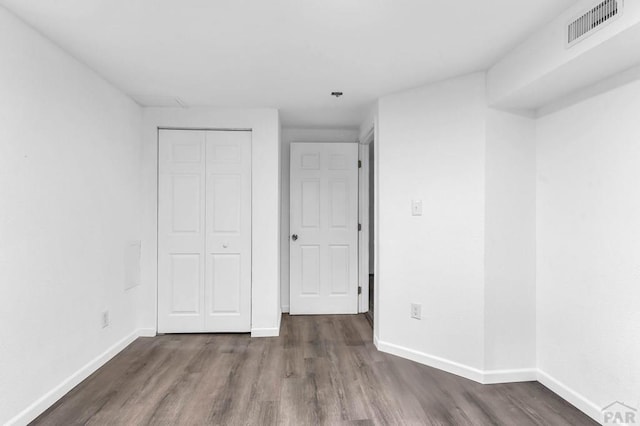 2720 E 8th St, Pueblo, CO 81001 - unfurnished bedroom featuring dark wood-style flooring and a closet