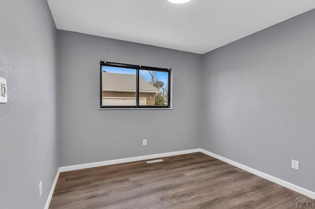 2720 E 8th St, Pueblo, CO 81001 - empty room with wood finished floors and baseboards