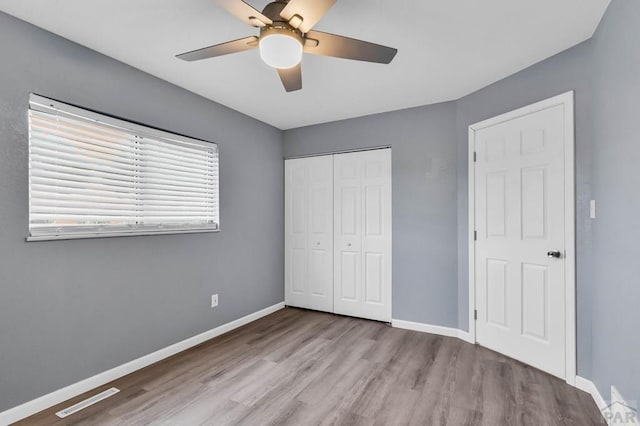 2720 E 8th St, Pueblo, CO 81001 - unfurnished bedroom with wood finished floors, a closet, and ceiling fan