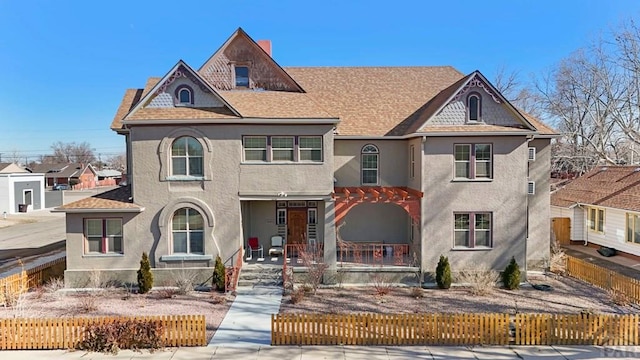 view of front of property featuring a fenced front yard, a shingled roof, and a pergola