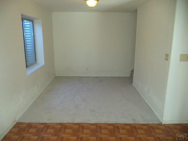 spare room featuring baseboards