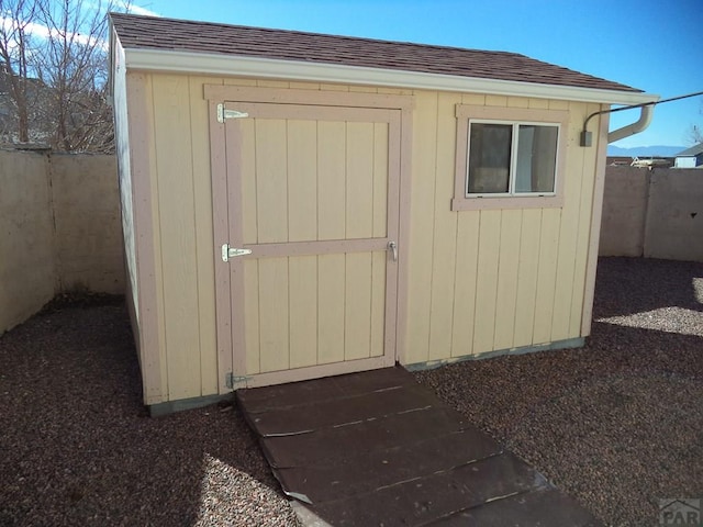 view of shed with fence