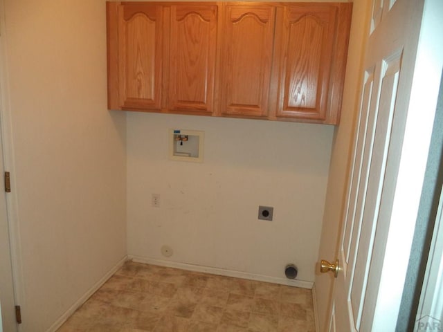 clothes washing area featuring baseboards, hookup for a washing machine, cabinet space, and hookup for an electric dryer