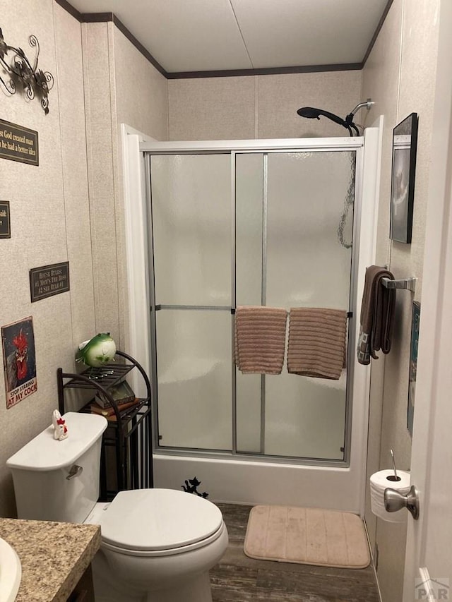 bathroom featuring crown molding, vanity, toilet, and wood finished floors