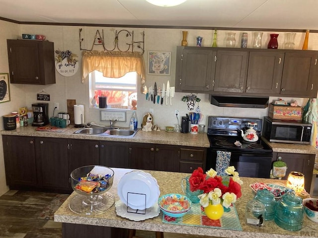 kitchen with light countertops, stainless steel microwave, a sink, and black electric range oven