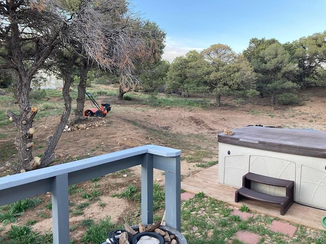 view of yard with a hot tub and a wooden deck