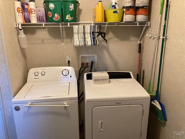 clothes washing area with laundry area and washer and dryer