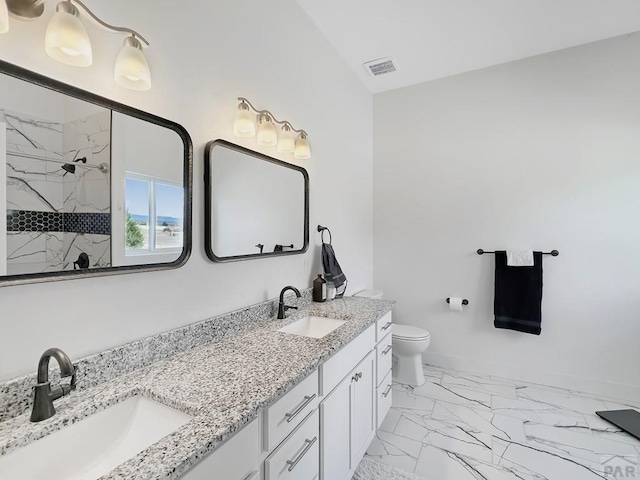 bathroom featuring visible vents, a sink, marble finish floor, and tiled shower