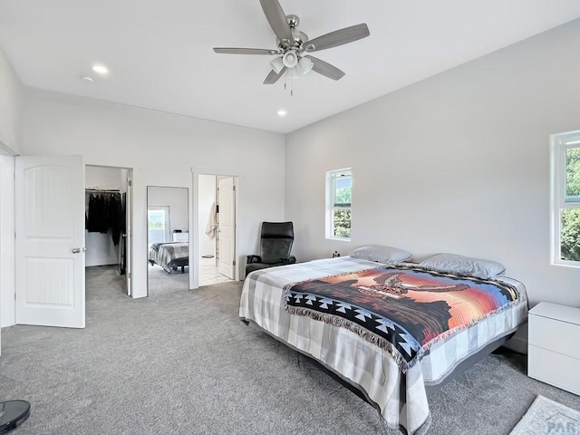 carpeted bedroom with recessed lighting, ceiling fan, a spacious closet, and multiple windows