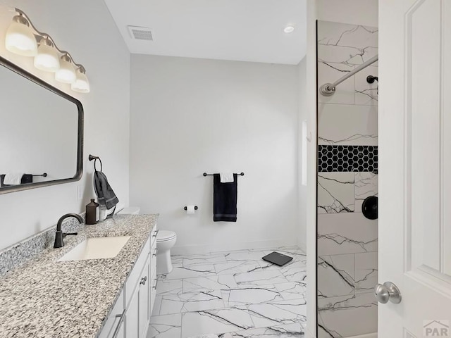 bathroom featuring a marble finish shower, vanity, marble finish floor, toilet, and visible vents
