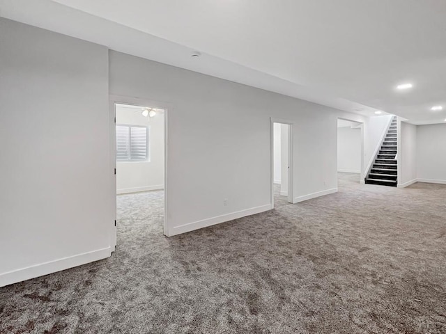below grade area with stairway, baseboards, carpet flooring, and recessed lighting