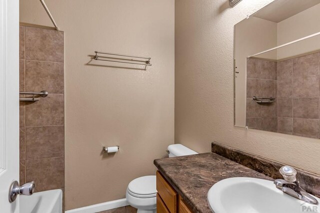 2208 Cowhand Pl, Pueblo, CO 81008 - full bathroom with shower / bathtub combination, vanity, baseboards, and toilet