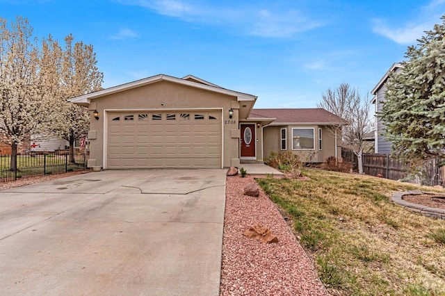 single story home featuring concrete driveway, a garage, stucco siding, and fence