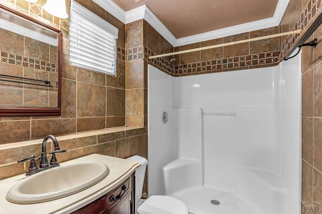 full bathroom featuring tile walls, toilet, crown molding, a shower stall, and vanity