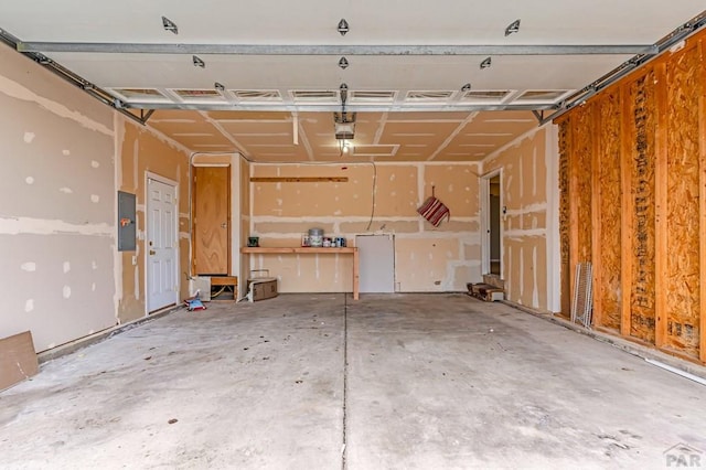 garage featuring electric panel and a garage door opener