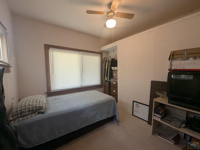 carpeted bedroom featuring a ceiling fan