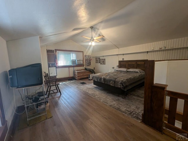bedroom featuring lofted ceiling, wood finished floors, cooling unit, and a ceiling fan