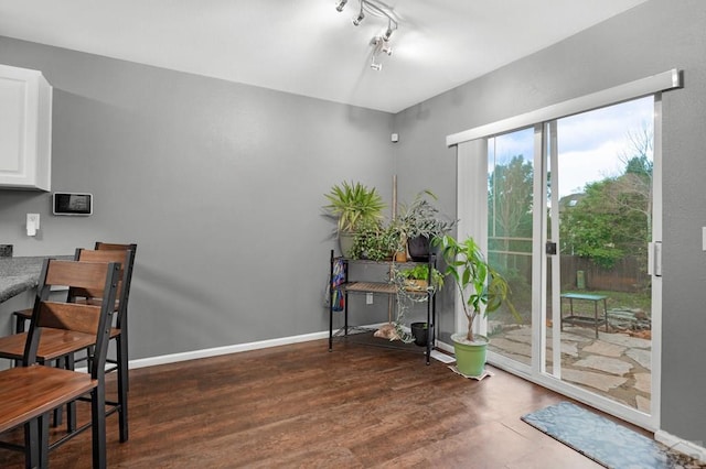 7365 Far Hill Dr, Colorado Springs, CO 80922 - dining space with wood finished floors, rail lighting, and baseboards