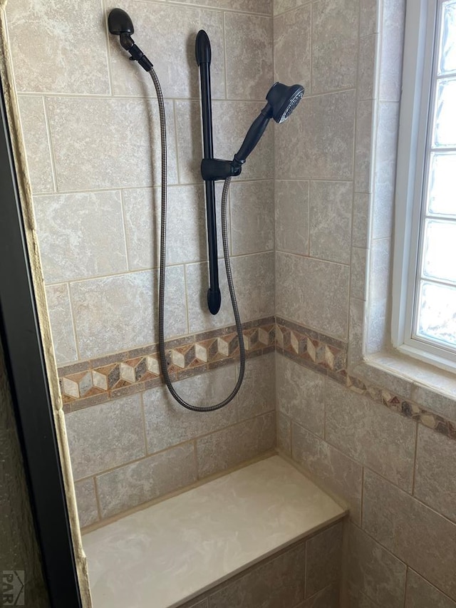 bathroom with a tile shower