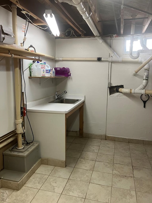 washroom featuring laundry area, a sink, and light tile patterned floors