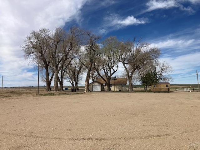 view of yard featuring a garage and fence