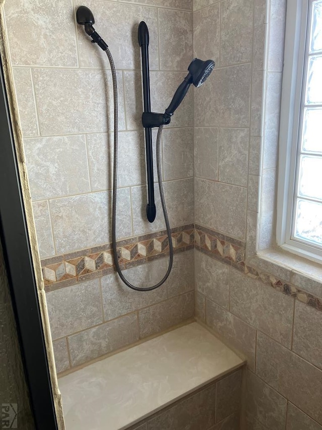 full bathroom with a tile shower