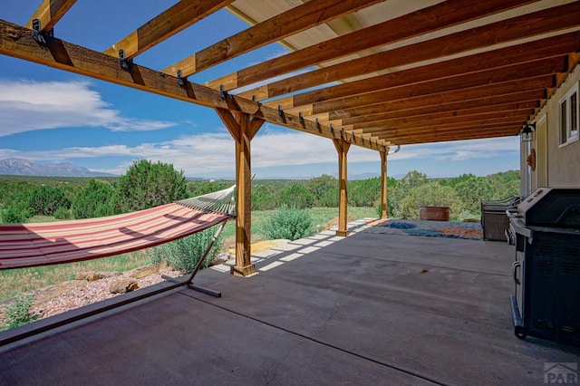 view of patio with a mountain view and a pergola