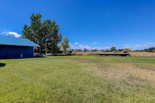 view of yard with a rural view