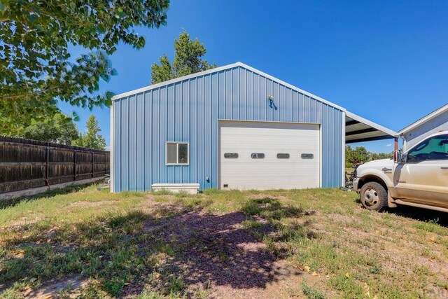 garage with a garage and fence