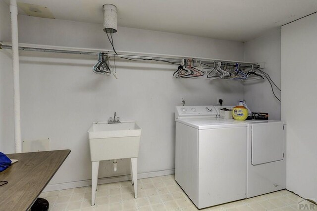 washroom featuring laundry area, light floors, independent washer and dryer, and baseboards