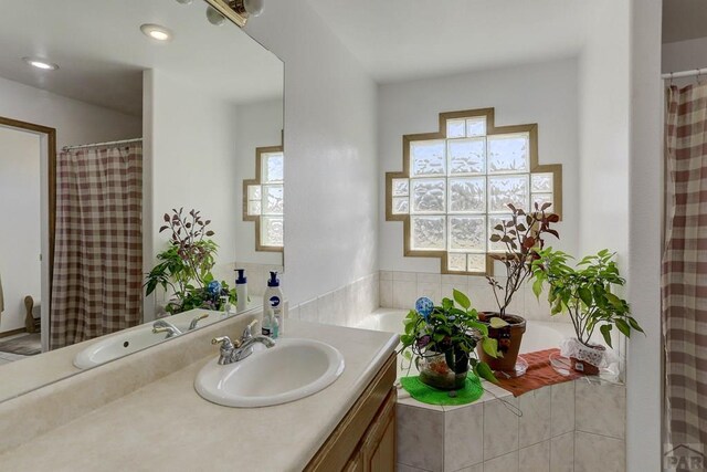 bathroom with vanity, a wealth of natural light, and recessed lighting