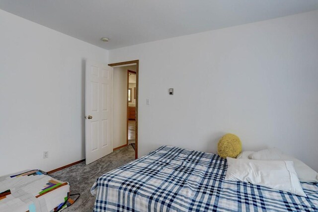 carpeted bedroom with baseboards