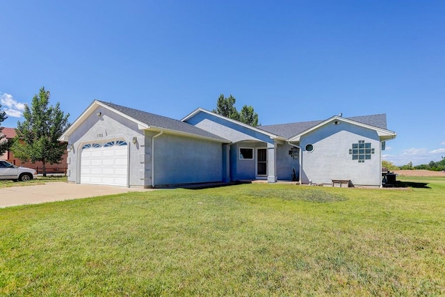 ranch-style home featuring a garage, driveway, a front lawn, and stucco siding