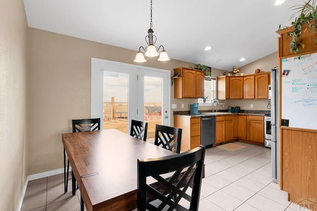 dining space with a notable chandelier, recessed lighting, light tile patterned flooring, vaulted ceiling, and baseboards