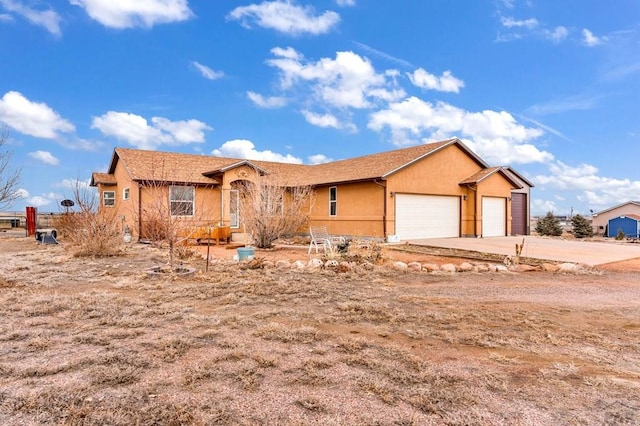 ranch-style house with an attached garage and stucco siding