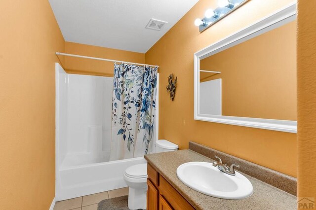 full bathroom featuring visible vents, shower / bathtub combination with curtain, toilet, vanity, and tile patterned flooring