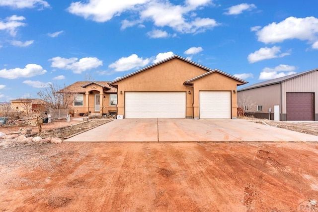 single story home featuring concrete driveway and stucco siding