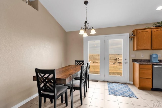 dining space with a chandelier, light tile patterned flooring, visible vents, and baseboards