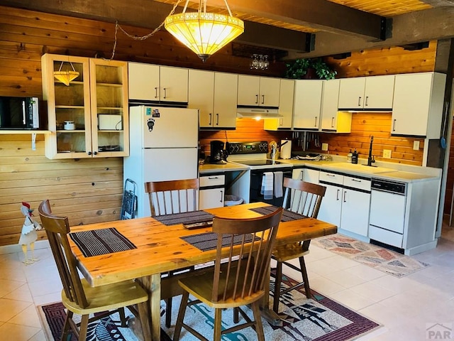 44 Valley Vista Rd Unit 35, Cuchara, CO 81055 - kitchen with white appliances, wood walls, under cabinet range hood, and light tile patterned floors