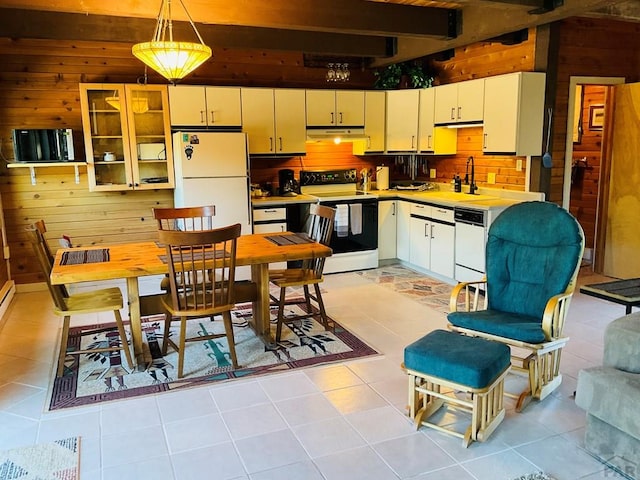 44 Valley Vista Rd Unit 35, Cuchara, CO 81055 - kitchen with white appliances, under cabinet range hood, a sink, beam ceiling, and wooden walls