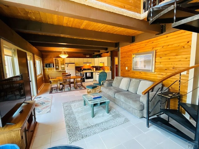 44 Valley Vista Rd Unit 35, Cuchara, CO 81055 - living area featuring beam ceiling, wooden walls, and stairway