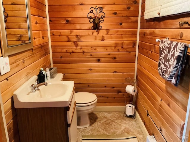 44 Valley Vista Rd Unit 35, Cuchara, CO 81055 - bathroom with toilet, vanity, tile patterned flooring, and wooden walls