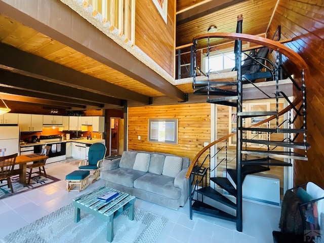 44 Valley Vista Rd Unit 35, Cuchara, CO 81055 - living area with stairs, light tile patterned flooring, a towering ceiling, beam ceiling, and wooden walls