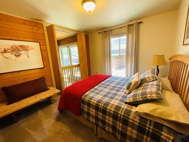 44 Valley Vista Rd Unit 35, Cuchara, CO 81055 - carpeted bedroom with access to outside and wooden walls