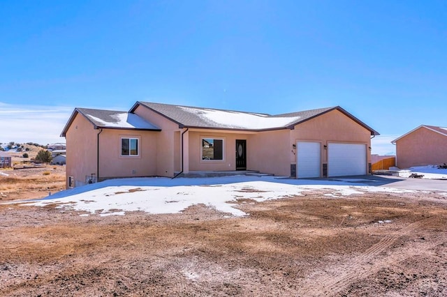 ranch-style home with an attached garage and stucco siding