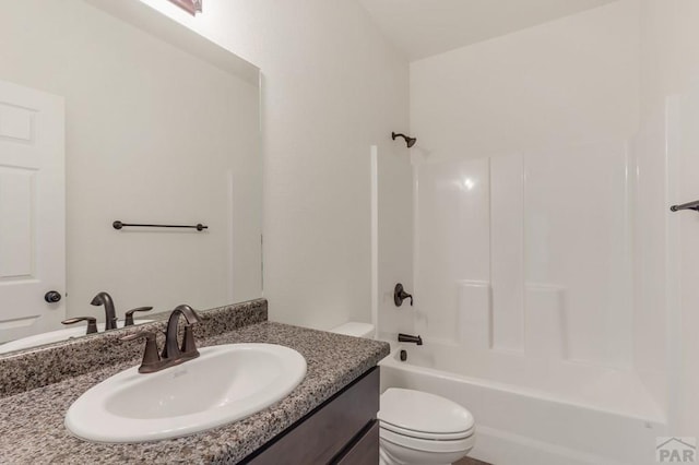 bathroom featuring vanity, shower / tub combination, and toilet